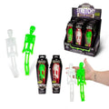 Neon green and white stretchy toy skeletons in coffin boxes, a store display stand, and held in a hand for scale.