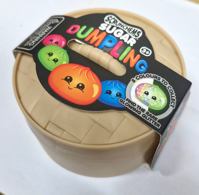 A Scrunchems Sugar Dumpling toy inside a tan plastic steamer basket with a black label showing colorful dumpling characters.