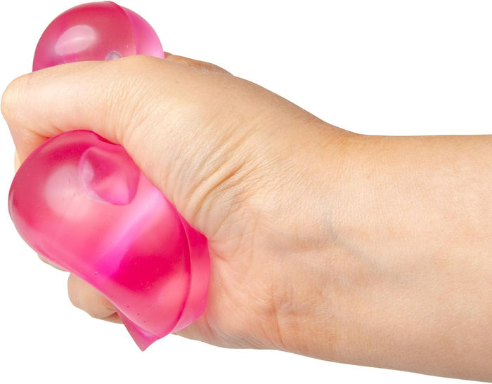 Hand squeezing a squishy, translucent pink pyramid-shaped toy.