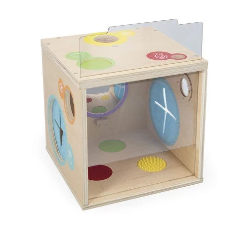 Light wood cube with colorful circular windows, textured floor pads, interior mirror, and a clear plastic side.