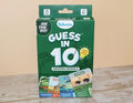 Green Skillmatics Guess in 10 game box with animal illustrations and a yellow lightbulb graphic on a wood surface.