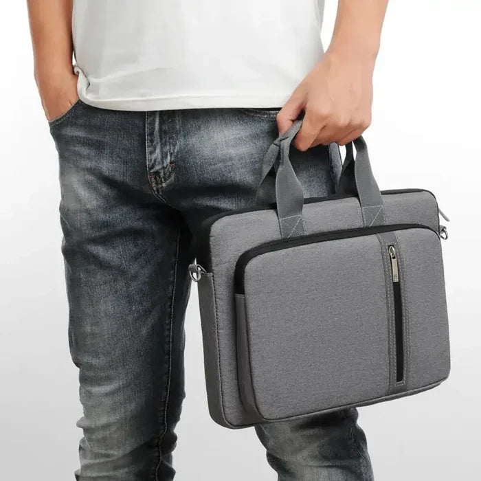 Person holding gray Sleeve Laptop Case For macbook case with zipper closure and handle, designed for protection and style.