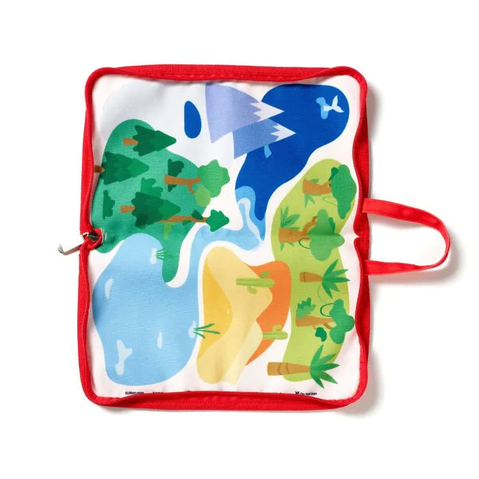 Open fabric play mat with red border and handle, featuring colorful illustrations of mountains, forest, lake, and desert.