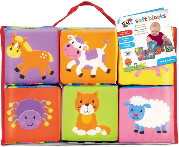 Six colorful soft blocks in a red-trimmed case, featuring cartoon animals like a horse, cow, spider, cat, and sheep.
