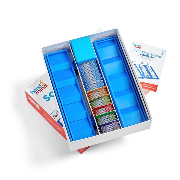 Open activity box with two blue tiered sorting trays, stacks of colorful cards, and an instruction booklet.