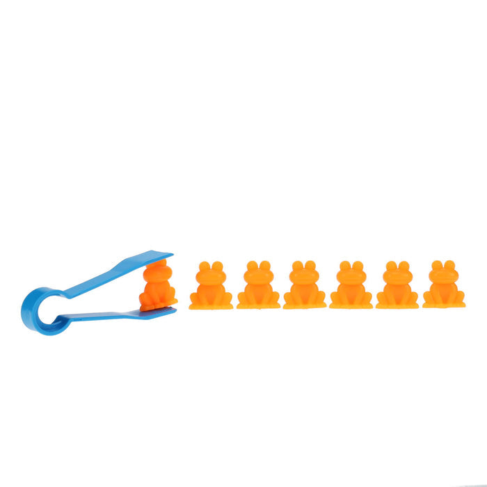 Blue plastic tweezers holding an orange frog toy next to a row of six more orange frogs on a white background.