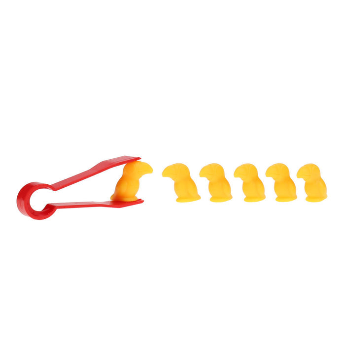 A red plastic tweezer holds a small yellow bird figurine next to a row of five identical yellow bird figurines.