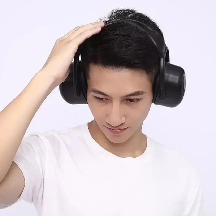 Man wearing Soundproof Earmuffs Professional Protection in black, touching the top with his hand.