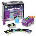 Purple toy rover, astronaut figure, blue obstacle, and coding cards displayed with product packaging.