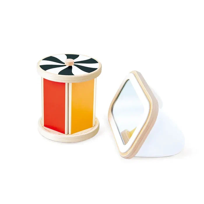 Wooden spinning drum with red and yellow panels and spiral top next to a matching angled mirror.