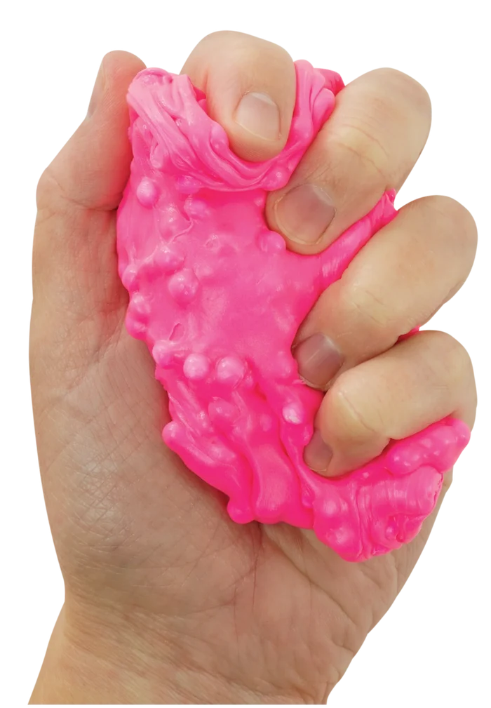 Bright pink, bumpy putty being squeezed by a hand, showing its squishy and stretchy texture.