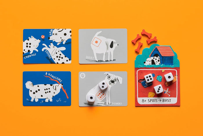 Dog-themed game cards, white dice, and red wooden bone pieces laid out on a bright orange background.