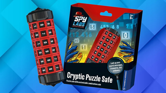 Red cylindrical safe with rotating number dials next to its spy-themed box on a blue geometric background.
