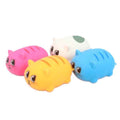 Four round, squishy cat toys in pink, yellow, blue, and white with large cartoon eyes and stripes.