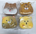 Four animal-faced squishies (dog, tiger, cat, and bear) in brown and yellow, individually wrapped in clear plastic.