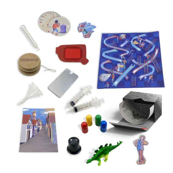 STEM toys: syringes, funnel, wooden yo-yo, green dinosaur, blue game board, magnifying glass, and colorful pawns.