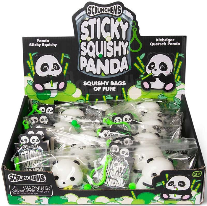 Retail display box containing individually bagged white and black panda squishy toys with green clips.