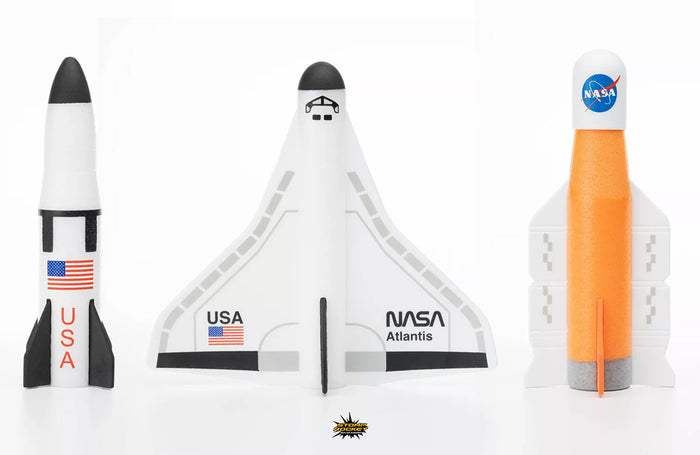 Three foam NASA toy spacecraft: a white rocket with black fins, a white space shuttle Atlantis, and an orange rocket.