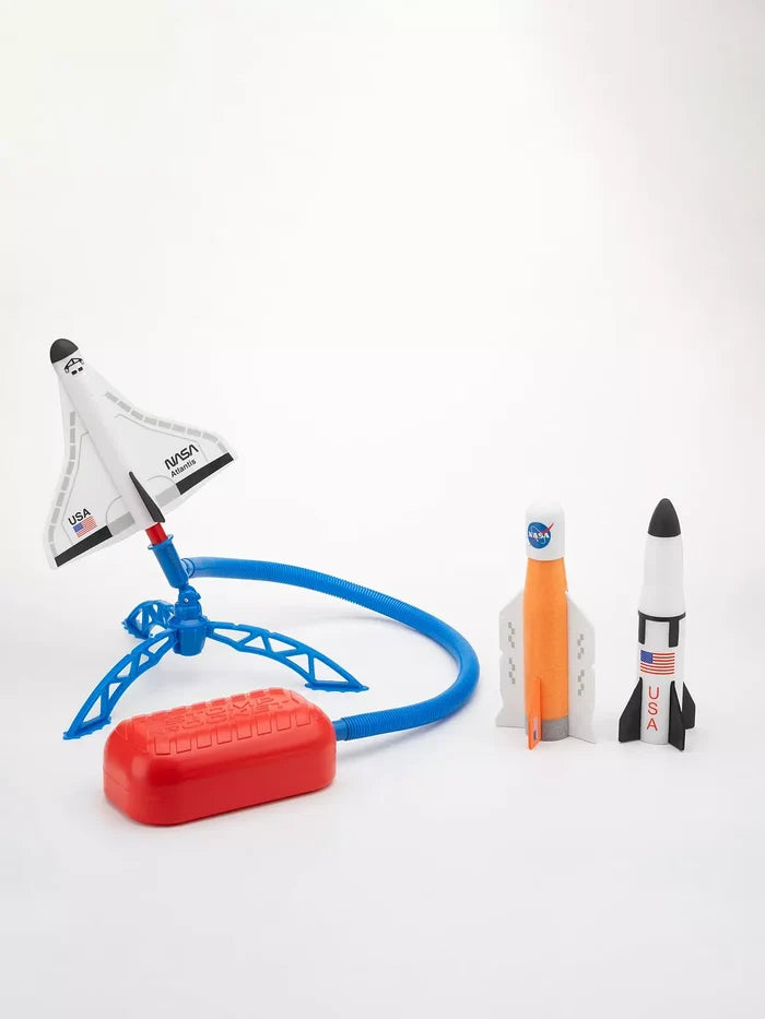 Foam NASA shuttle and rockets on a blue launcher connected by a blue hose to a red stomp pad, against a white backdrop.