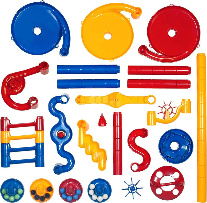 Assorted red, blue, and yellow plastic marble run pieces, including tubes, funnels, and tracks on a white background.