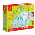 Hape Super Stylish Hair Salon Set in lime green packaging showing wooden toy styling tools and a blue apron.