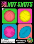 Colorful packaging featuring a pink basketball, yellow tennis ball, pink soccer ball, and blue football squishy toys.