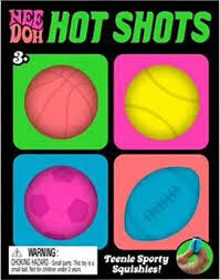Colorful packaging featuring a pink basketball, yellow tennis ball, pink soccer ball, and blue football squishy toys.