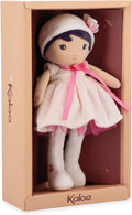 Soft doll with dark hair, white hat, and pink dress inside a peach Kaloo brand gift box.
