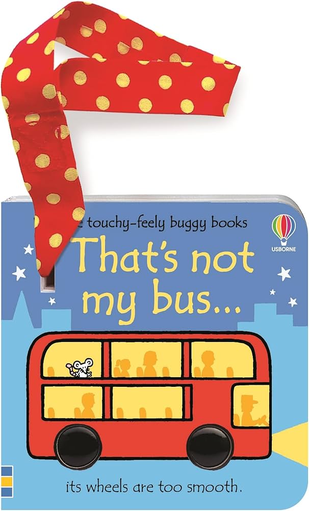 Blue board book featuring a red double-decker bus with shiny black wheels and a red polka-dot buggy attachment strap.