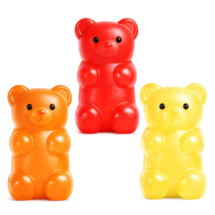 Three glossy, gummy-bear-shaped squishy toys in red, orange, and yellow with cute black eyes and smiling faces.
