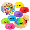 Colorful squishy dumplings with happy faces shown with a mystery steamer basket and a rainbow edition dumpling.