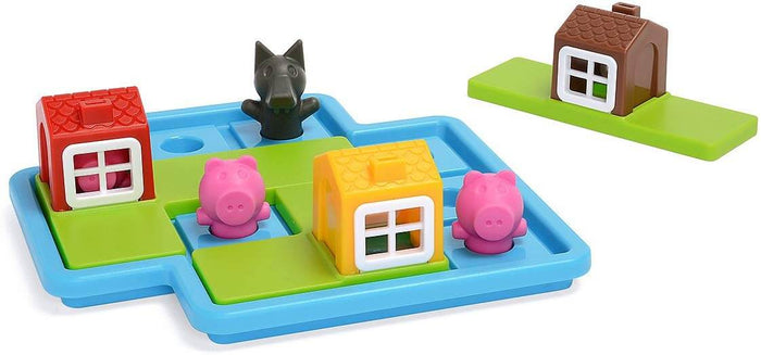 Blue puzzle board with pink pig figures, a black wolf, and red, yellow, and brown toy houses on green tile bases.