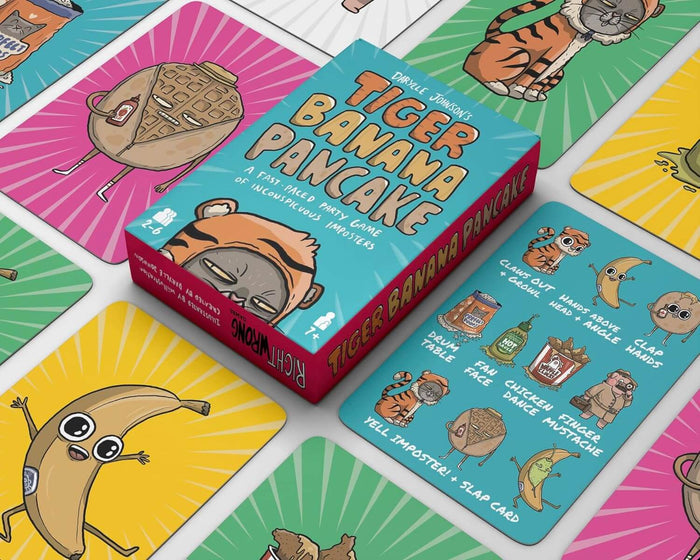 Teal game box and vibrant cards featuring whimsical cartoon tiger, banana, and pancake characters.