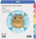 Brown bear toy with a blue and white striped spinning base, displayed in a white Tiger Tribe product box.