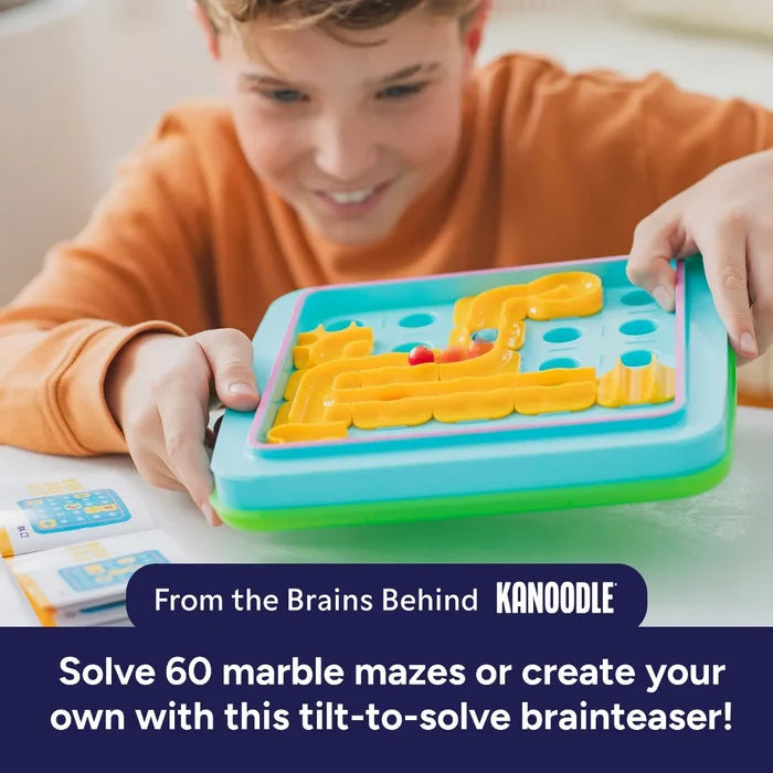 Child playing with a blue handheld tilt game featuring yellow maze tracks and red and blue marbles.