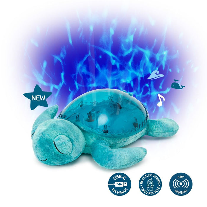 Teal plush turtle projects blue ocean wave patterns. Icons show USB-C, recycled fabric, and cry sensor features.
