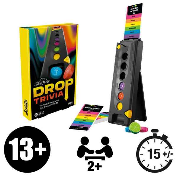 Yellow board game box next to a black vertical tower, colored circular discs, and rainbow-striped trivia cards.
