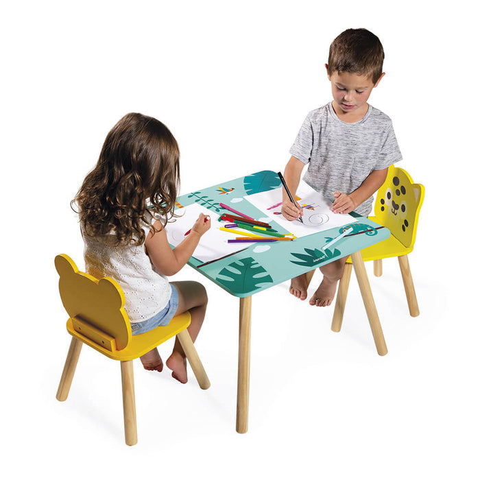 Two children drawing at a blue tropical table with yellow animal-shaped chairs and light wood legs.