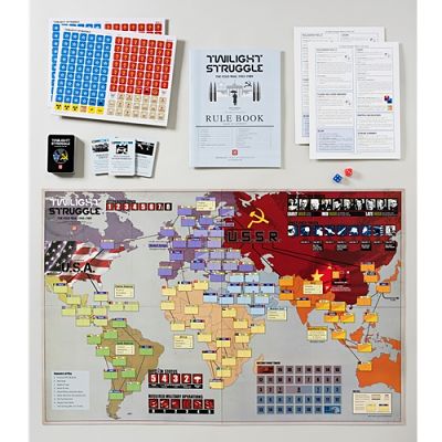 World map game board with colorful regions, white rule book, red and blue square counters, game cards, and two dice.