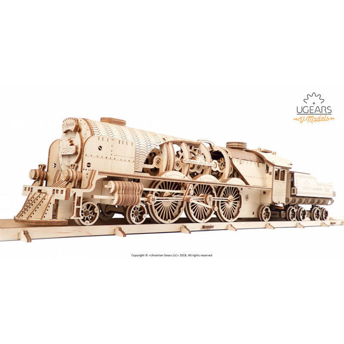 Intricate light wood 3D steam train puzzle with visible mechanical gears and spoked wheels on a wooden track.