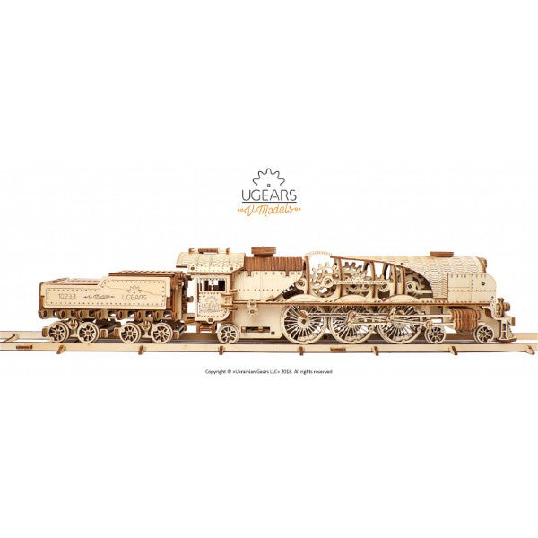 Detailed light-wood locomotive and tender model on tracks with intricate mechanical gears and spoked wheels.