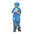 Child in blue vet scrubs, cap, and mask, holding a plush dog with a stethoscope around their neck.