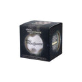 White cratered bouncy ball inside a black box with star patterns and Waboba MoonShine branding.