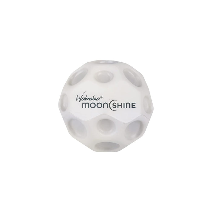 White spherical ball with moon-like craters and black Waboba MOONSHINE logo text.