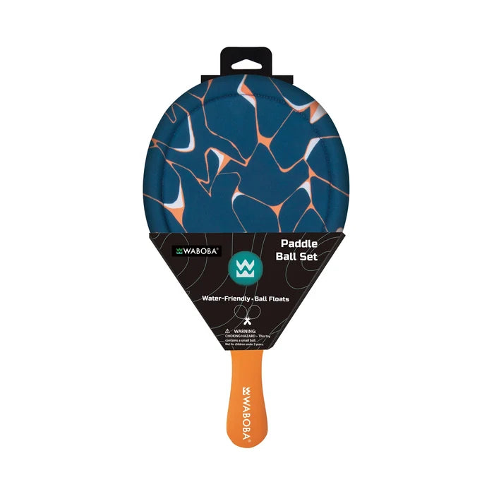 Teal round beach paddle with orange and white abstract pattern and orange handle in black retail packaging.