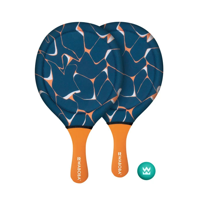 Two round beach paddles with blue and orange geometric patterns and orange handles next to a small teal ball.