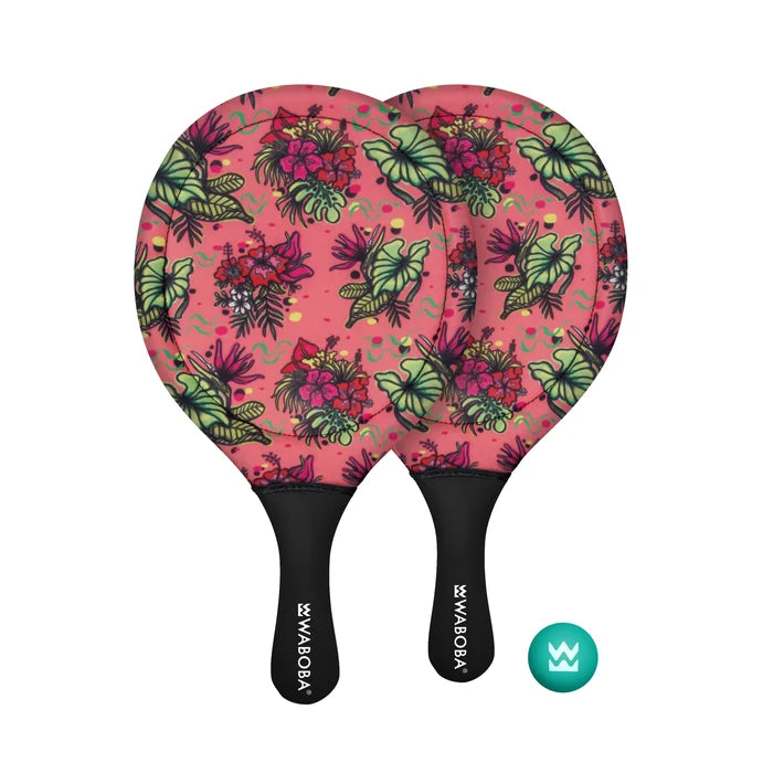 Two pink beach paddles with a tropical floral print and black handles next to a teal ball with a crown logo.