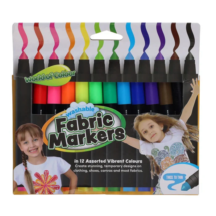 12 vibrant rainbow fabric markers in a box showing two girls wearing t-shirts decorated with marker designs.