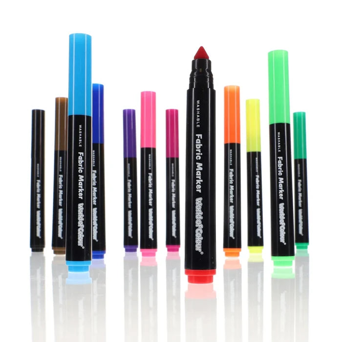 12 colorful fabric markers with black barrels and bright caps. One red marker is uncapped to show its tip.