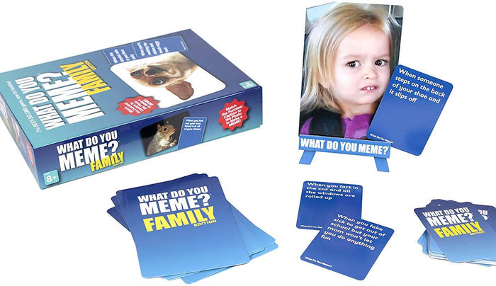 Light blue game box with blue caption cards and a meme photo of a girl displayed on a matching small easel.